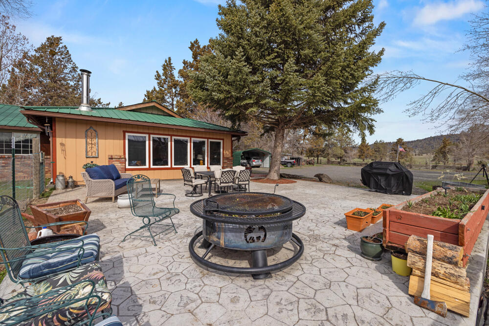 47477 Gerber Road Bonanza, OR 97623 - Photo 60 of 63 a view of a patio with couches and chairs under an umbrella