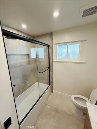 a bathroom with a shower toilet and sink