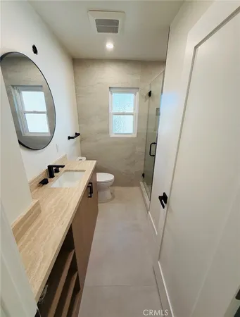 a bathroom with a sink a toilet and a mirror