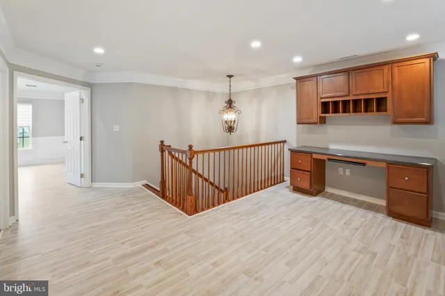 a view of a kitchen with a sink cabinets and wooden floor