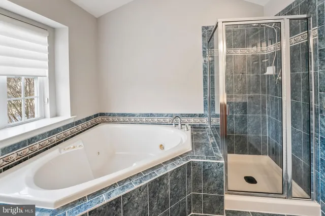 a bathroom with a tub and shower