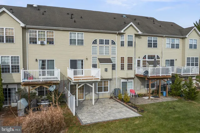 a front view of residential houses with outdoor space and seating