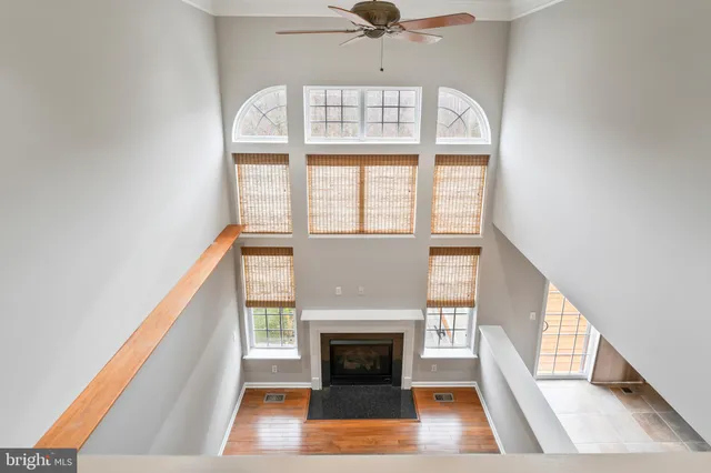 a living room with a fireplace and a large window