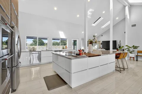 a large kitchen with a table and chairs
