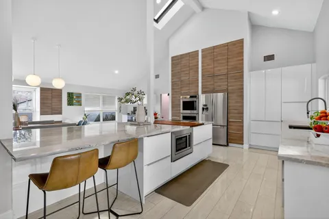 a living room with furniture workspace and a flat screen tv