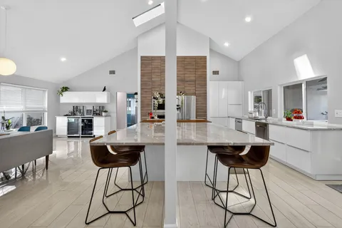 a bedroom with a bed and a flat tv screen on the dresser