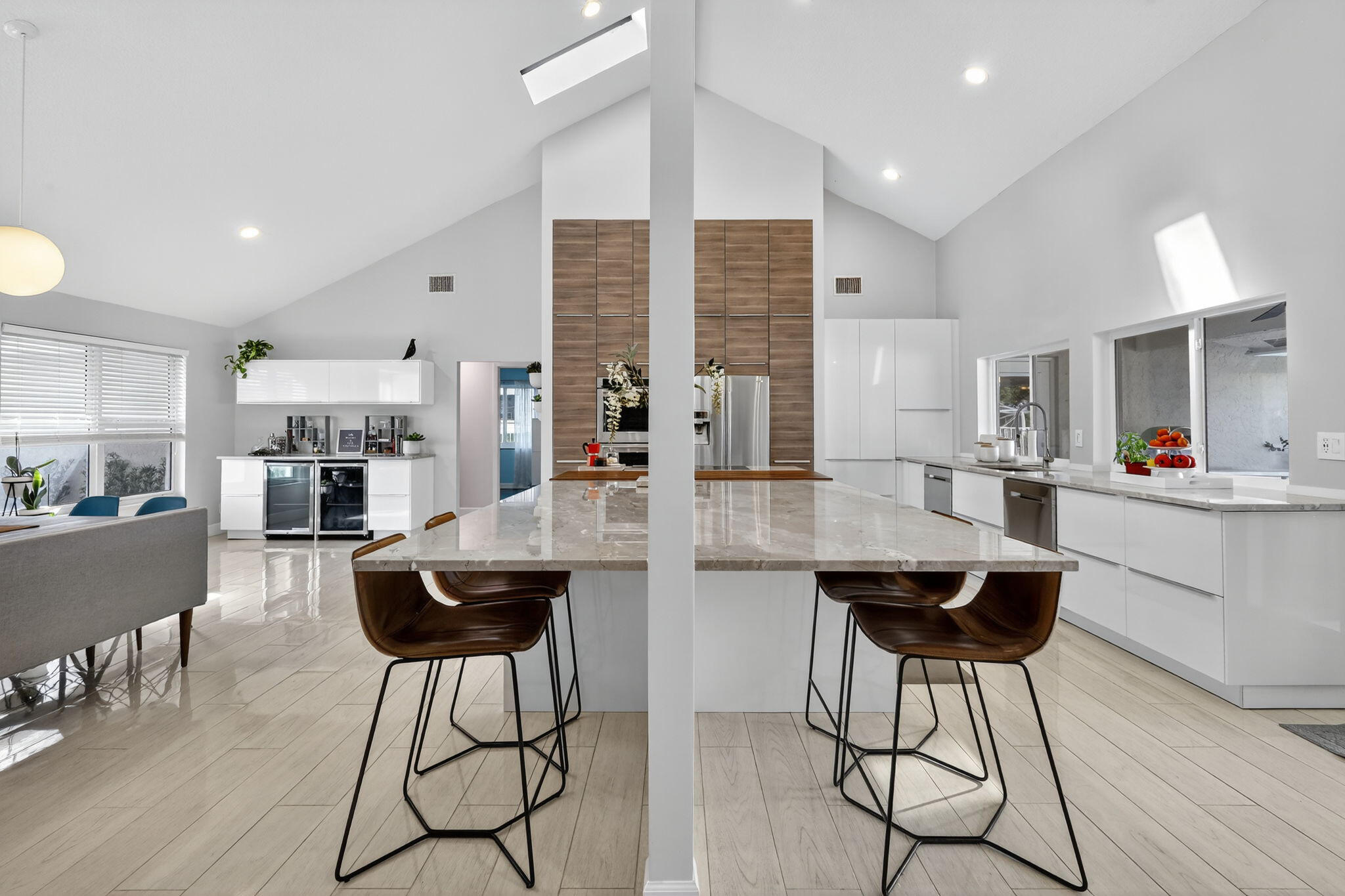 4275 Fox Trace Road Boynton Beach, FL 33436 - Photo 19 of 69 a kitchen with stainless steel appliances kitchen island granite countertop a dining table chairs and view of living room