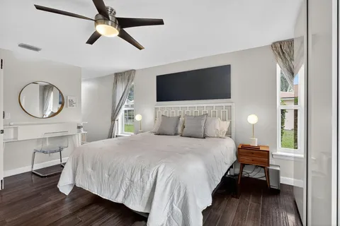 a view of a workspace with furniture and wooden floor