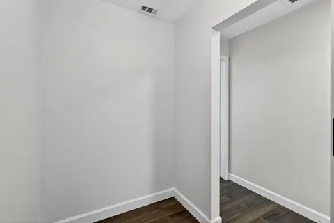 a living room with furniture cabinets and window