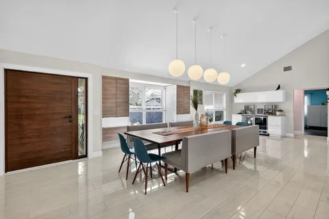 a view of a dining room with furniture and window