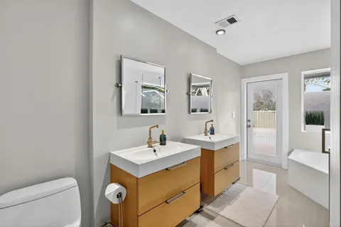 a view of a workspace with furniture and wooden floor
