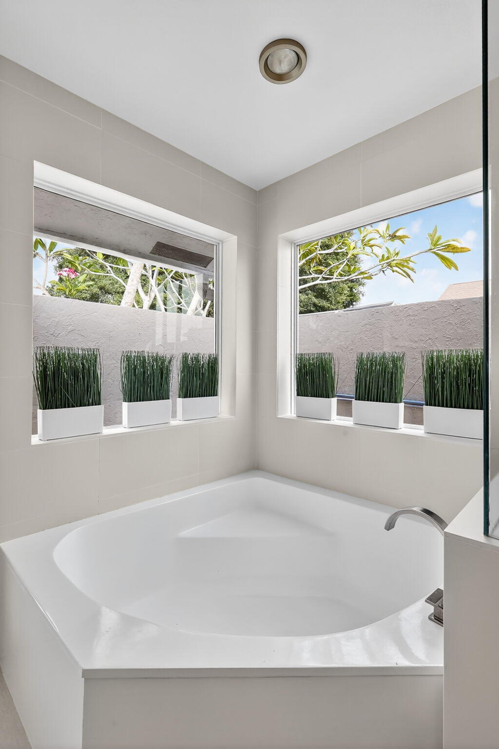 4275 Fox Trace Road Boynton Beach, FL 33436 - Photo 35 of 69 a white bath tub sitting in a bathroom next to a window