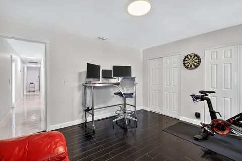 a view of a house with a big yard and potted plants