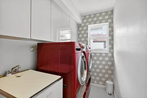 a view of a house with a big yard plants and large trees