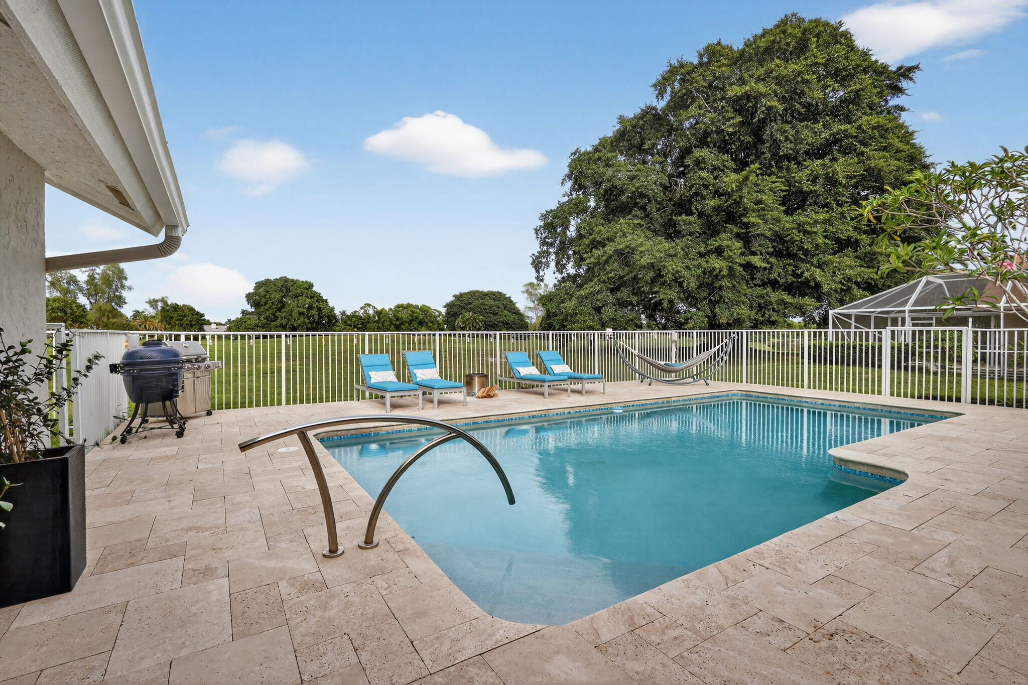 4275 Fox Trace Road Boynton Beach, FL 33436 - Photo 54 of 69 a view of a swimming pool with a lounge chair