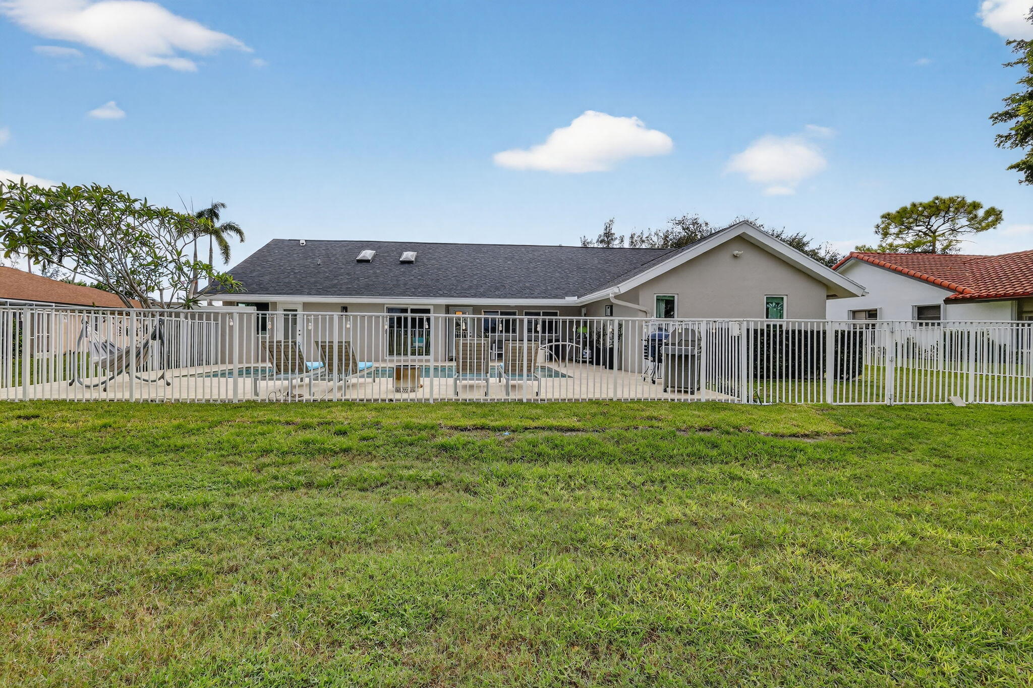 4275 Fox Trace Road Boynton Beach, FL 33436 - Photo 60 of 69 a view of a house with a big yard and potted plants