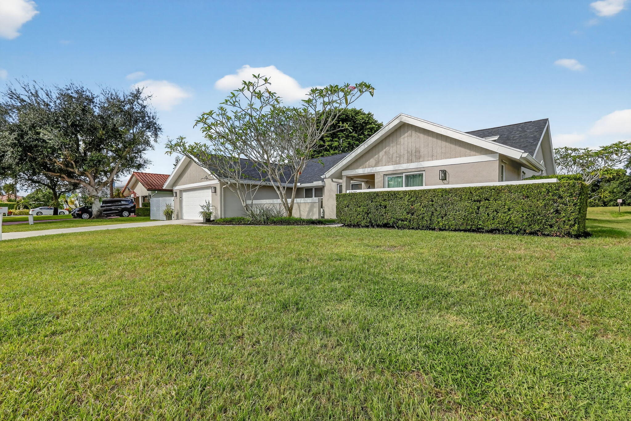 4275 Fox Trace Road Boynton Beach, FL 33436 - Photo 65 of 69 a front view of a house with garden