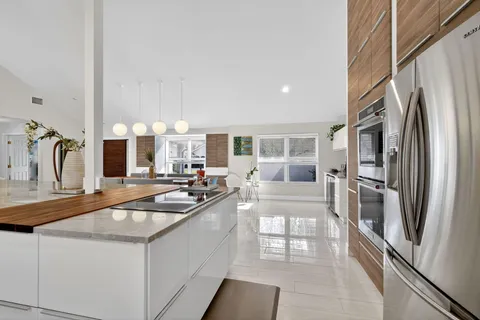 a living room with furniture a dining table and kitchen view