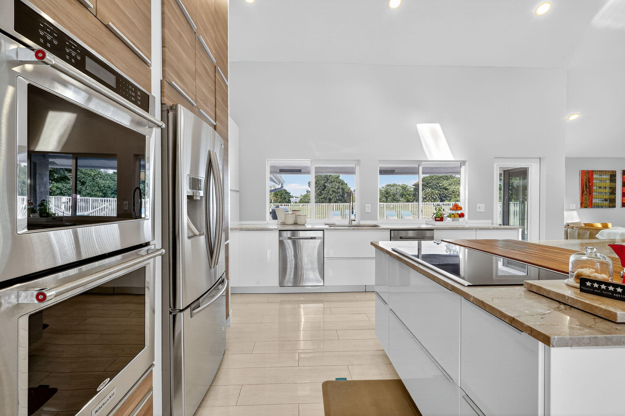 4275 Fox Trace Road Boynton Beach, FL 33436 - Photo 9 of 69 a kitchen with stainless steel appliances granite countertop a sink and a refrigerator