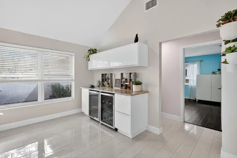 a kitchen with kitchen island granite countertop a sink and a stove top oven