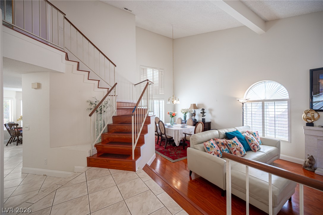 718 Rusty Spur Drive Henderson, NV 89014 - Photo 3 of 50 A striking dual-level living area with rich hardwood floors and an elegant staircase.