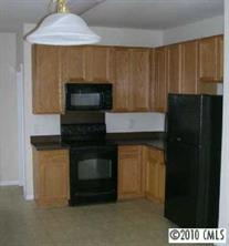 6324 Trotters Ridge Road Charlotte, NC 28227 - Photo 3 of 8 a kitchen with a stove and a microwave