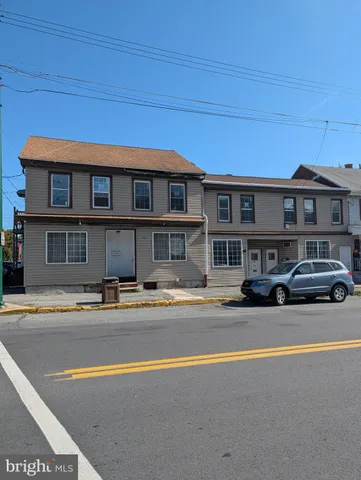 a front view of a house with swimming pool and outdoor space