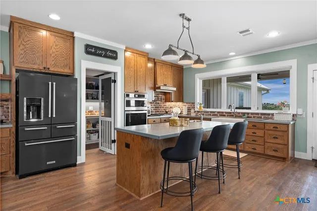 a kitchen with stainless steel appliances a sink and stove