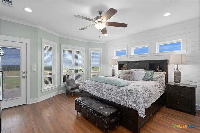 a bedroom with a large bed and a window