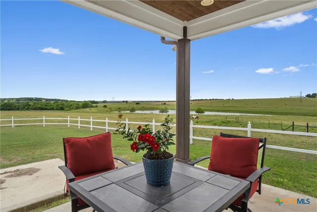 a view of a patio with a table and chairs