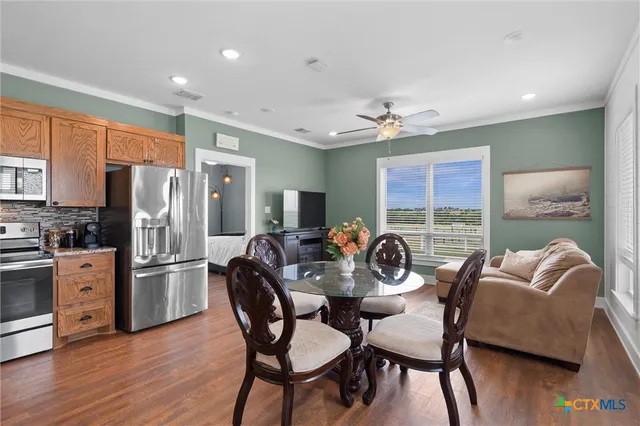 a view of a dining room with furniture window and wooden floor