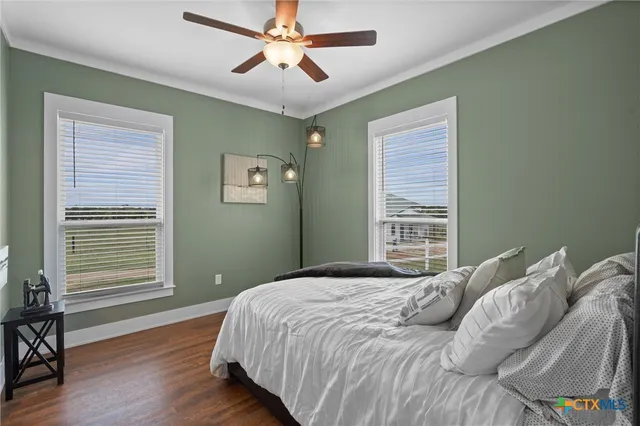 a bedroom with a large bed and a window