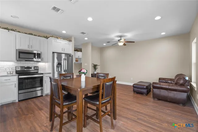 a view of a dining room with furniture and wooden floor