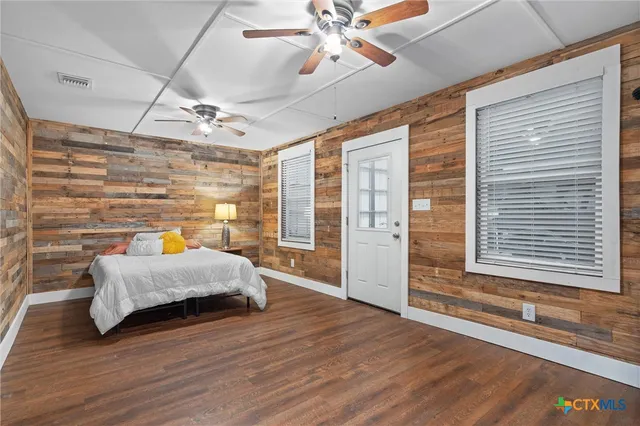 a spacious bedroom with a bed and a walk in closet