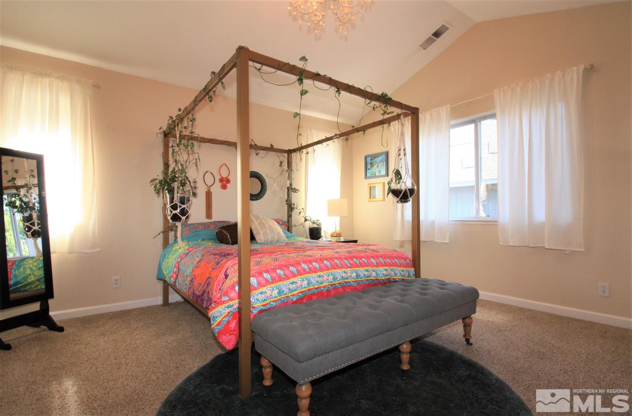 470 Len Circle Reno, NV 89511 - Photo 11 of 24 a bedroom with a bed and a mirror