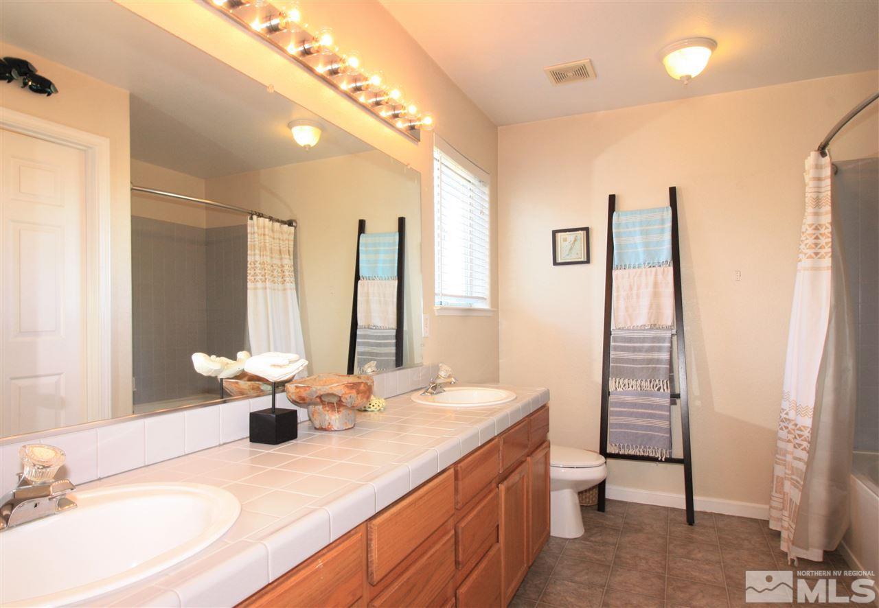 470 Len Circle Reno, NV 89511 - Photo 13 of 24 a dining room with stainless steel appliances furniture a window and kitchen view