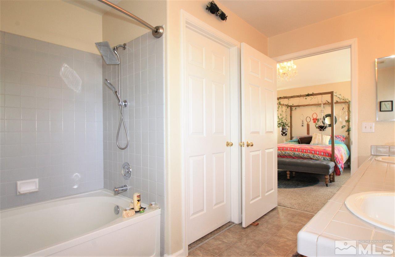 470 Len Circle Reno, NV 89511 - Photo 14 of 24 a en suite bathroom with a tub shower and sink