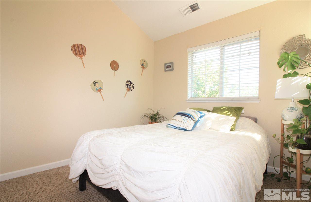 470 Len Circle Reno, NV 89511 - Photo 16 of 24 a bedroom with a bed and a window