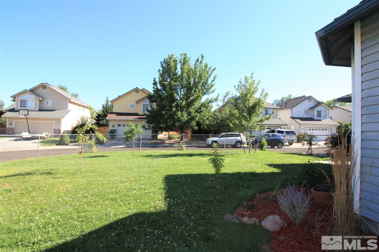 470 Len Circle Reno, NV 89511 - Photo 22 of 24 a view of a house with a yard and a garden