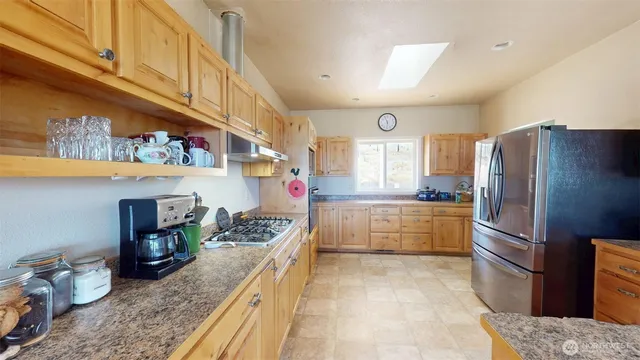 a view of a livingroom with furniture and a window