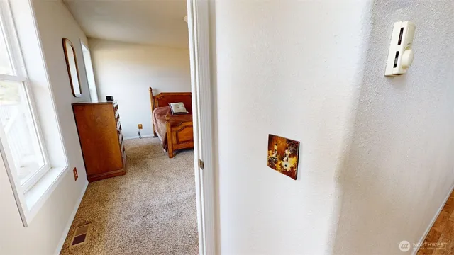 a bedroom with a bed table and a window