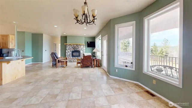 a view of a livingroom with workspace and a window