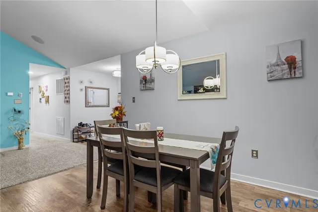 a view of a dining room with a table and chairs
