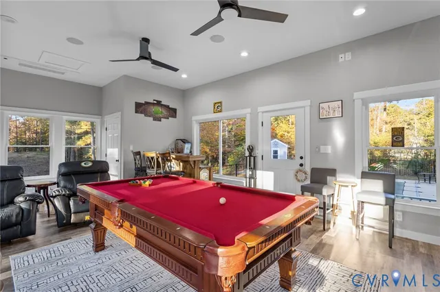 a room with pool table and windows