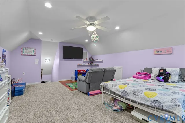 a bedroom with furniture and a flat screen tv