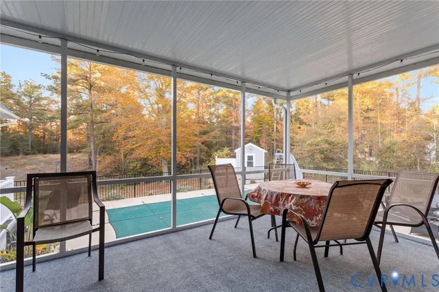 a dining room with furniture water view and a backyard