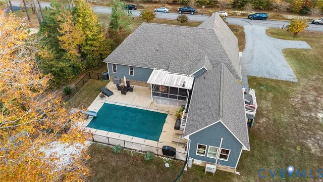an aerial view of a house with swimming pool and patio