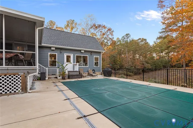 a view of a house with backyard porch and sitting area