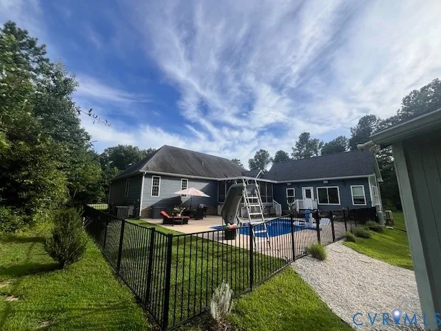a view of a house with wooden deck and furniture