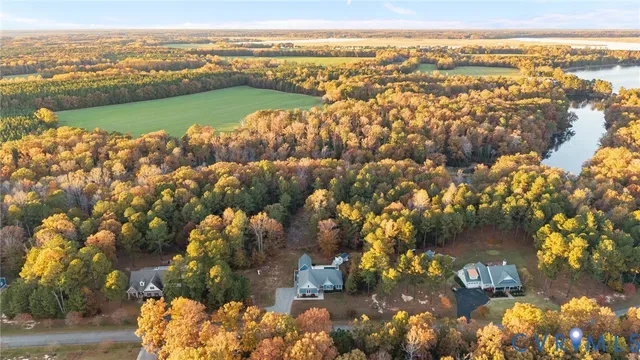 an aerial view of residential building with outdoor space and lake view